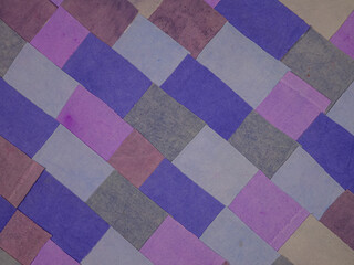 Fototapeta premium Handmade background in patchwork style with cotton fabric elements in purple tones 