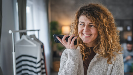 woman with curly hair at home use mobile phone smartphone have a call