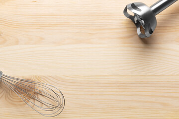 Electric hand blender on a wooden background. Top view. Space for text.