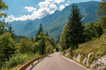 straight mountain road to the the Julian Alps in the background. Slovenia