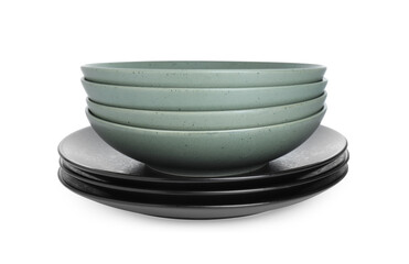 Stack of beautiful ceramic plates and bowls isolated on white