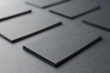 Blank business cards on black background, closeup. Mockup for design