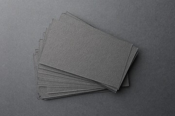 Blank business cards on black background, top view. Mockup for design