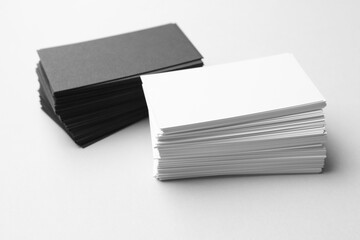 Blank business cards on white background, closeup. Mockup for design