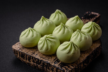 Raw khinkali or green dumplings with salt, spices and herbs