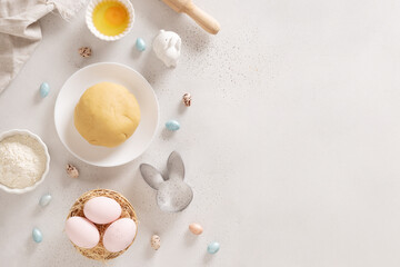 Preparation and cook Easter cookies, cookie cutters, raw dough on baking white background. Top view. Greeting card
