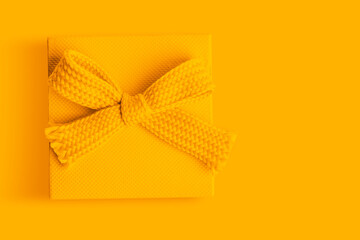 yellow with a bow on an yellow background.