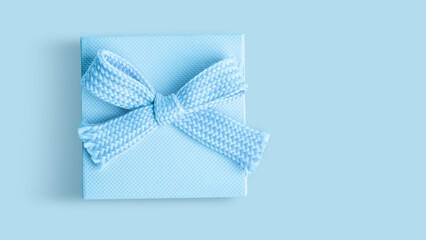 Light blue box with a bow on an Light blue background.