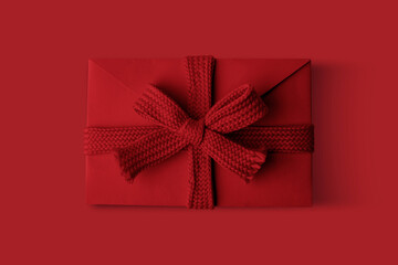 Red envelope with a bow on a Red background.