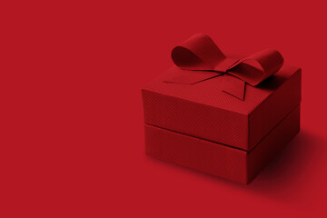 Dark red box with a bow on a red background.