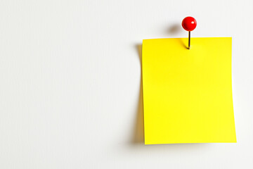 one yellow colored sticky note pinned on a white background, Empty blank note paper stick on white board, pinned Reminder memo isolated on flat wall, Yellow color blank sheet paper on white background