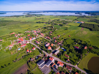 Aerial view of beautiful Radzieje village (former Rosengarten, East Prussia), Mamry, Labap and Dargin lakes in the background, Mazury, Poland - 724199317