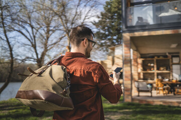 Naklejka premium Portrait of one man happy caucasian male with travel bag at his house