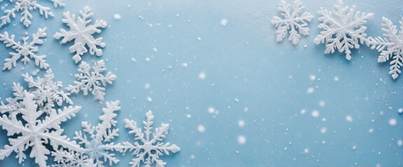 White snowflakes shining in sunlight against light blue backdrop