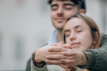 couple with hands clasped outdoors