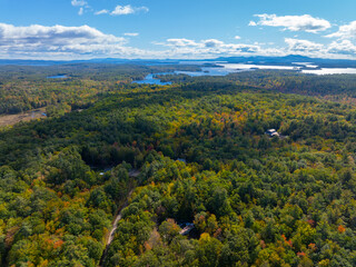 Fototapeta na wymiar Aerial view of Lake Winnipesaukee with sunshine through clouds in fall from town of Moutonborough, New Hampshire NH, USA. 