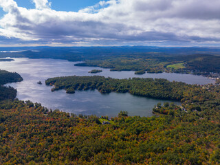 Obraz premium Aerial view of Lake Winnipesaukee with sunshine through clouds in fall from town of Moutonborough, New Hampshire NH, USA. 