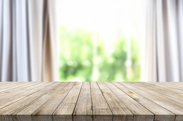 Wooden table on window background with garden and trees