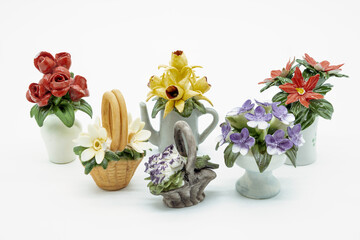Antique Miniature Flower Ornaments bone china in the shape of baskets jugs and vases of different colours of flowers.