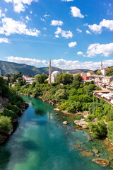 Fototapeta na wymiar Picturesque Neretva River flows through the historic town of Mostar, Bosnia and Herzegovina