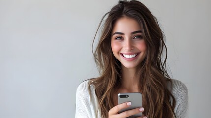 Smiling young woman stares at her mobile phone while texting, messaging and browsing social networks - Powered by Adobe
