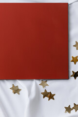 Festive Mood: Red Book and Golden Stars on White Fabric