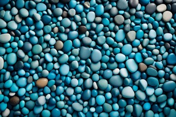 A backdrop of nature-inspired pebbles, each a different shade of blue, together forming a textured stone surface that evokes a vintage sea pebble beach in turquoise