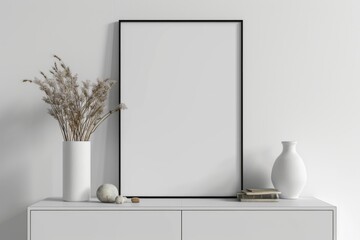a white cabinet hangs below a blank poster frame