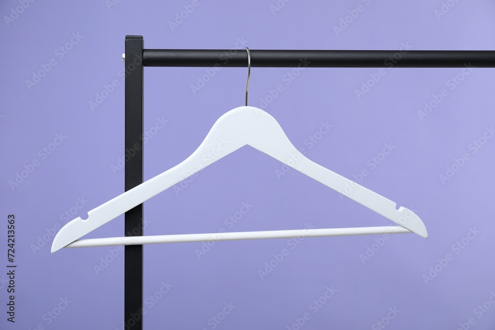 Poster White clothes hanger on rack against purple background