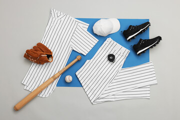 Flat lay composition with baseball uniform and sports equipment on color background