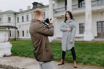 Photographer Capturing a Model Outside a Historic Building