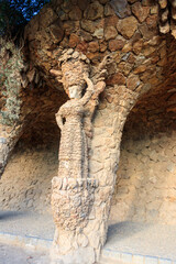 Stone sculpture of a woman on a column in park Guell in Barcelona, Spain