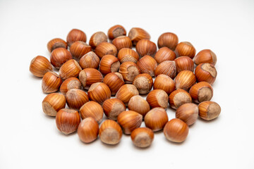 natural hazelnuts on white surface - close macro photo - isolated
