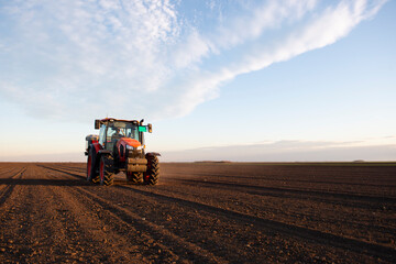 Tractor spreading artificial fertilizers