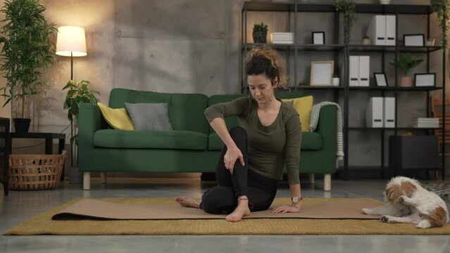 Woman practice yoga on mat in living room at home slow motion
