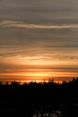 clouds swirl as the sun sets over the lake