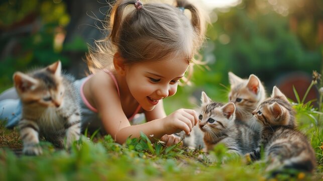 Girl is playing with kittens 