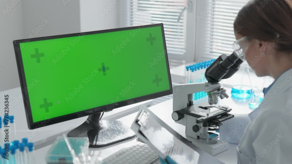 Poster chroma key green screen. in the light of the laboratory, the chemist improves his research by conduc