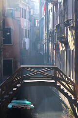 Narrow, hazy canal in Venice.