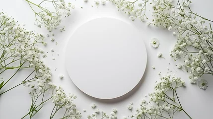 Fotobehang White round frame with small delicate white flowers on white background. wedding cards, bridal shower or other party invitation cards, Place for text. Flat lay, top view. © Mahnoor
