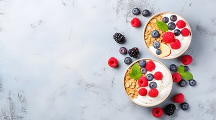 Fototapeta na wymiar Two healthy breakfast bowl with ingredients granola fruits Greek yogurt and berries top view. Weight loss, healthy lifestyle and eating concept