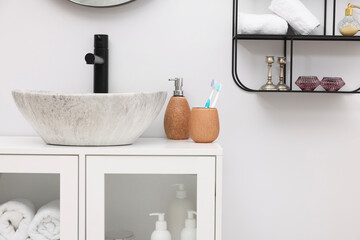 Different bath accessories, personal care products and bathroom vanity indoors