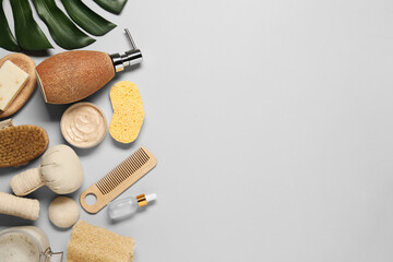 Bath accessories. Flat lay composition with personal care products on light grey background, space...