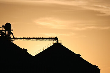 Silhouetted Grain Bins at Sunset © StevertS