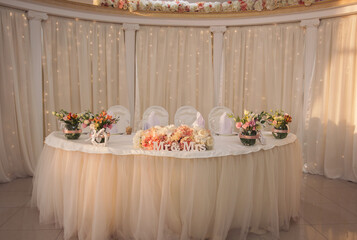 Wedding banquet decoration in tender and warm creamy, pink and beige colors. 