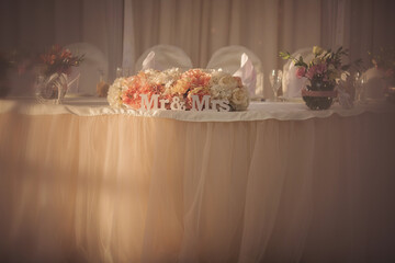 Wedding banquet decoration in tender and warm creamy, pink and beige colors. 