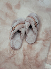 Fuzzy beige slippers. Perfect for a relaxing day at home or a cozy night in.