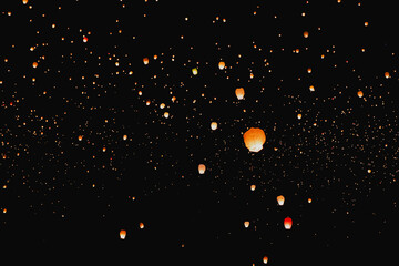 Night sky filled with glowing floating lanterns