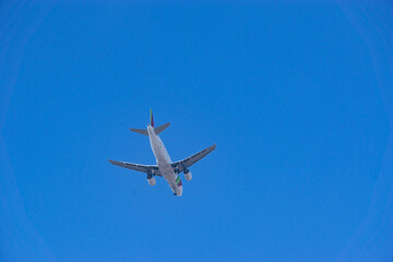 An airplane flying on a clear blue sky