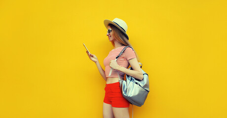 Summer portrait of happy traveler young woman 20s with mobile phone looking at device